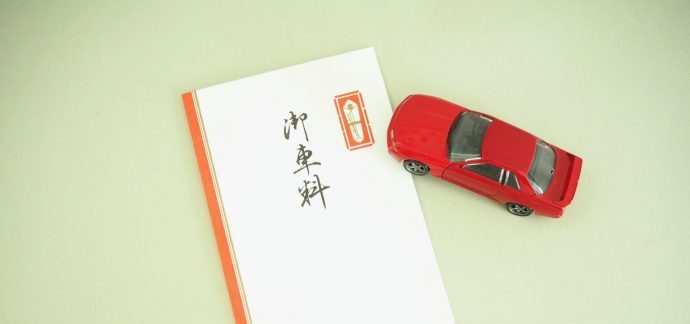 御車料と書かれたご祝儀袋と赤いミニカーの写真