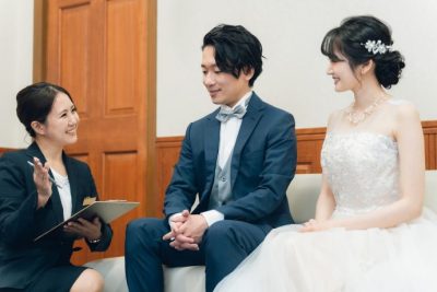 女性プランナーと話す新郎新婦の写真