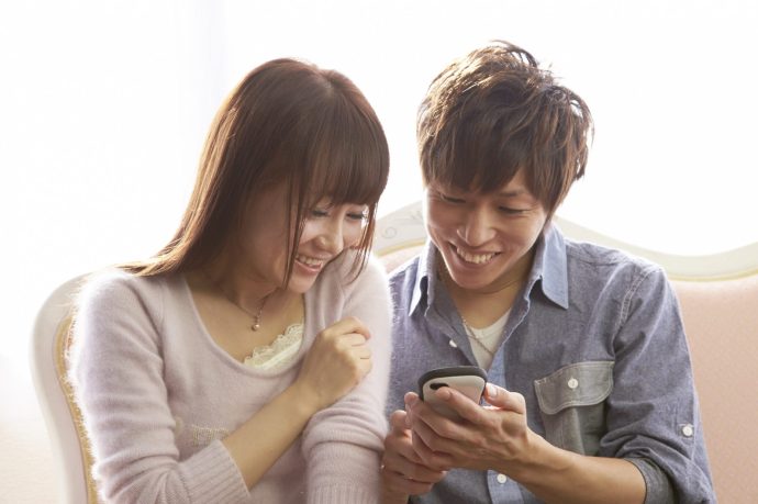 スマホを覗き込む若い男女