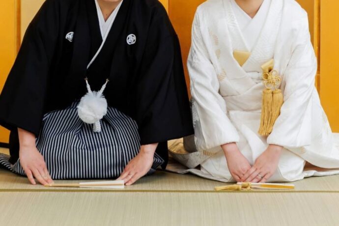 画像：和装で三つ指着く新郎新婦