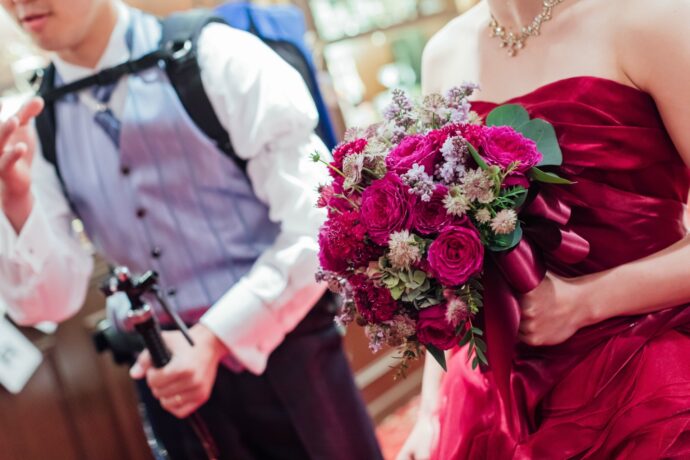 画像：ビールサーバーを背負った新郎と赤いドレスの新婦