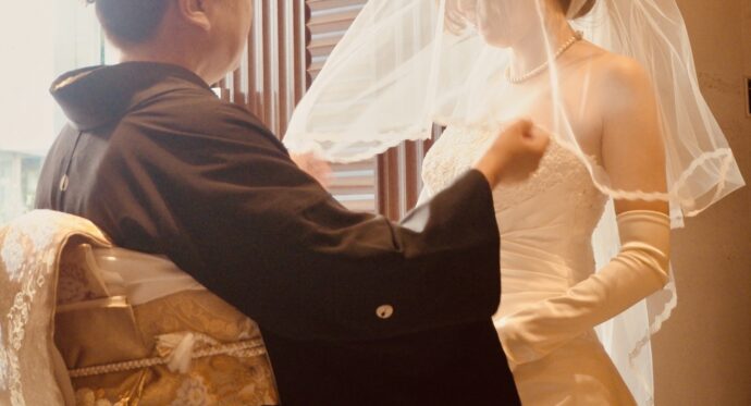 画像：ベールダウンする黒留袖の女性